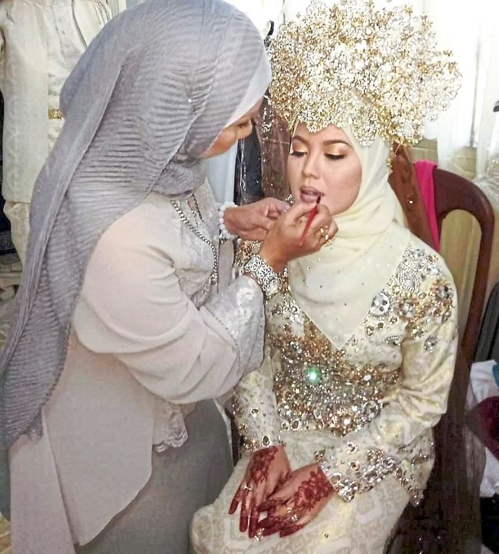 Almost perfect: Istiadziah carefully applying makeup to a bride on her wedding day.