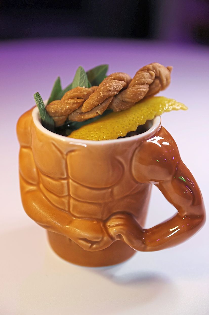 The Gym Bro cocktail is topped with a twisted cookie.