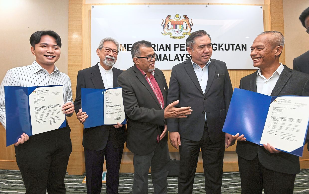 Boosting service: Loke with his deputy Datuk Hasbi Habibollah (third from left) meeting with representatives from the three companies at the Transport Ministry in Putrajaya. —  AZHAR MAHFOF/The Star