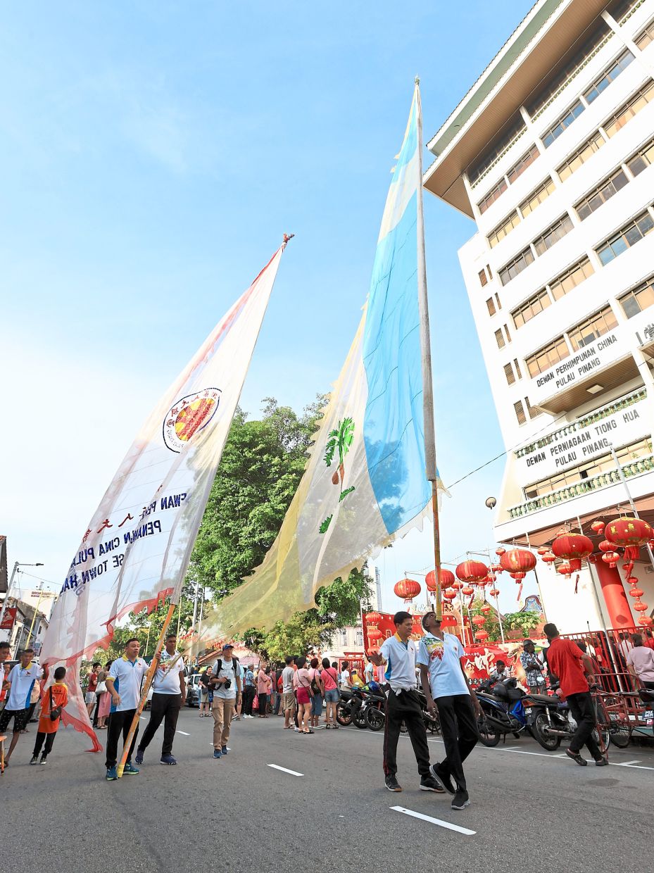 Chingay performers entertaining the crowd with their skills during the Penang Chinese Town Hall Lunar New Year Open House.