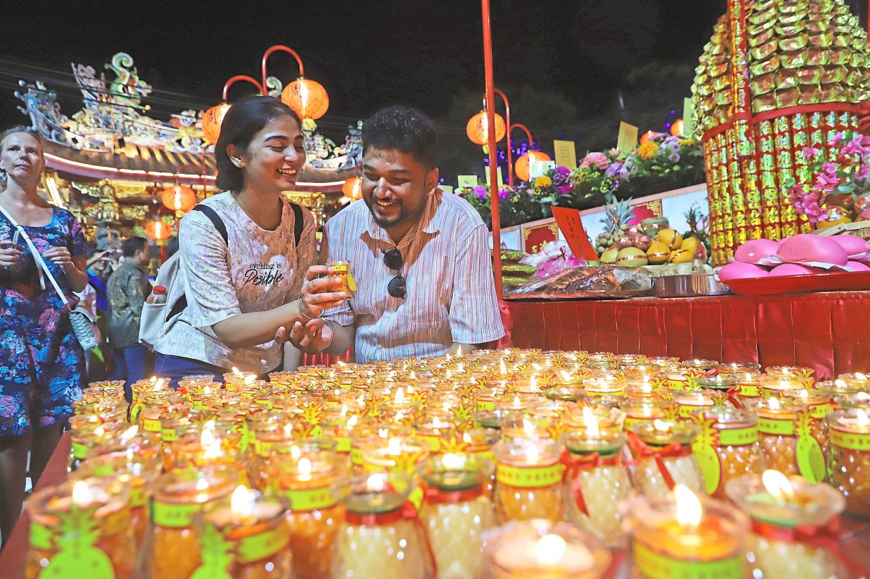 Arnav (right) and Aishwarya at an altar during the Jade Emperor’s Birthday celebration at Chew Jetty.
