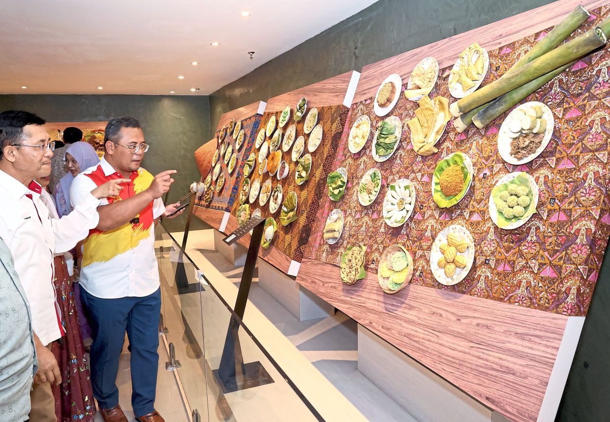 (Above, from left) Borhan and Amirudin looking at replicas of traditional Selangor food during the launch. 