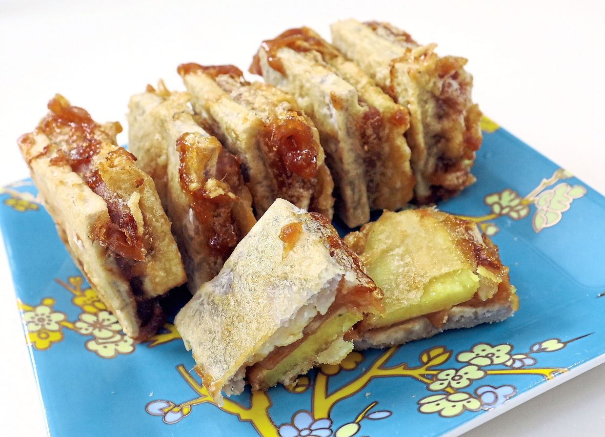 Fried kuih bakul is an irresistible snack that reminds us that although the celebrations may have ended, the year has just begun. — Photos: AZLINA ABDULLAH/The Star