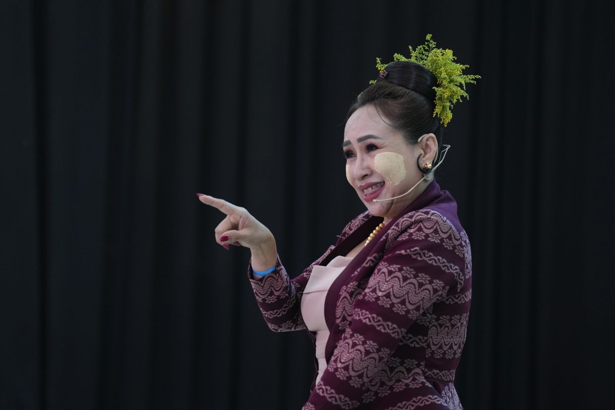 A Yangon theatre performer in traditional attire applies thanakha during a performance competition promoting its Unesco heritage bid. Photo: AP