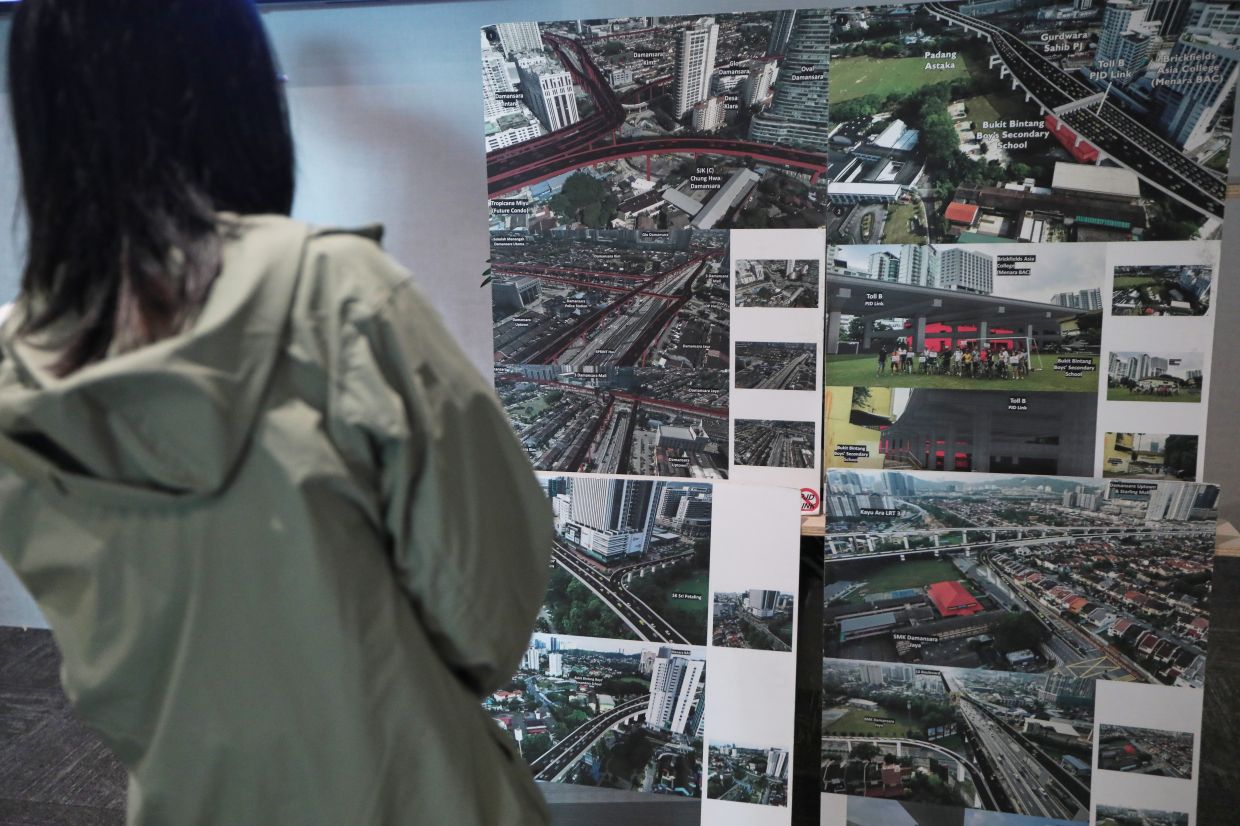 A Petaling Jaya resident viewing some of the alternative ideas presented at a townhall session.