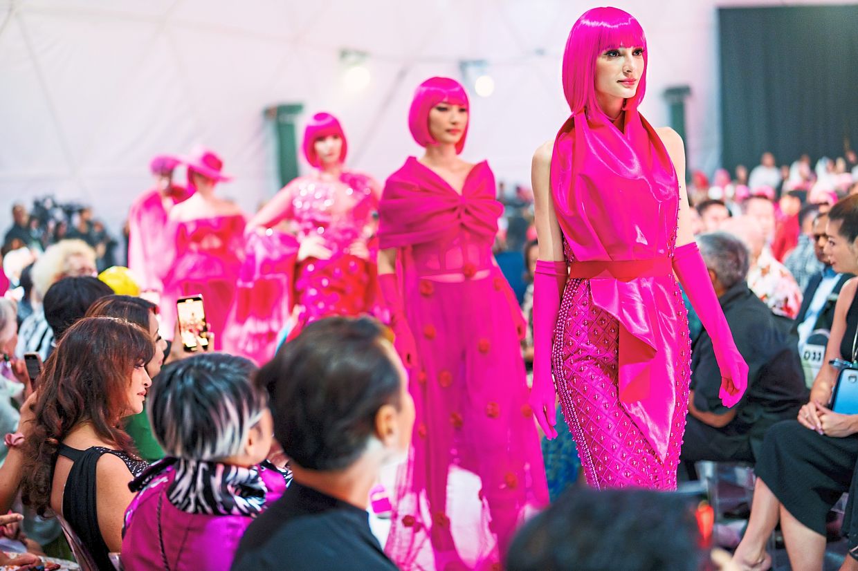 While he loves bold designs that stand out, as seen in this photo on the runway at the 2023 Kuala Lumpur Fashion Week, he also thinks that everyday clothes should be practical. Photo: KLFW