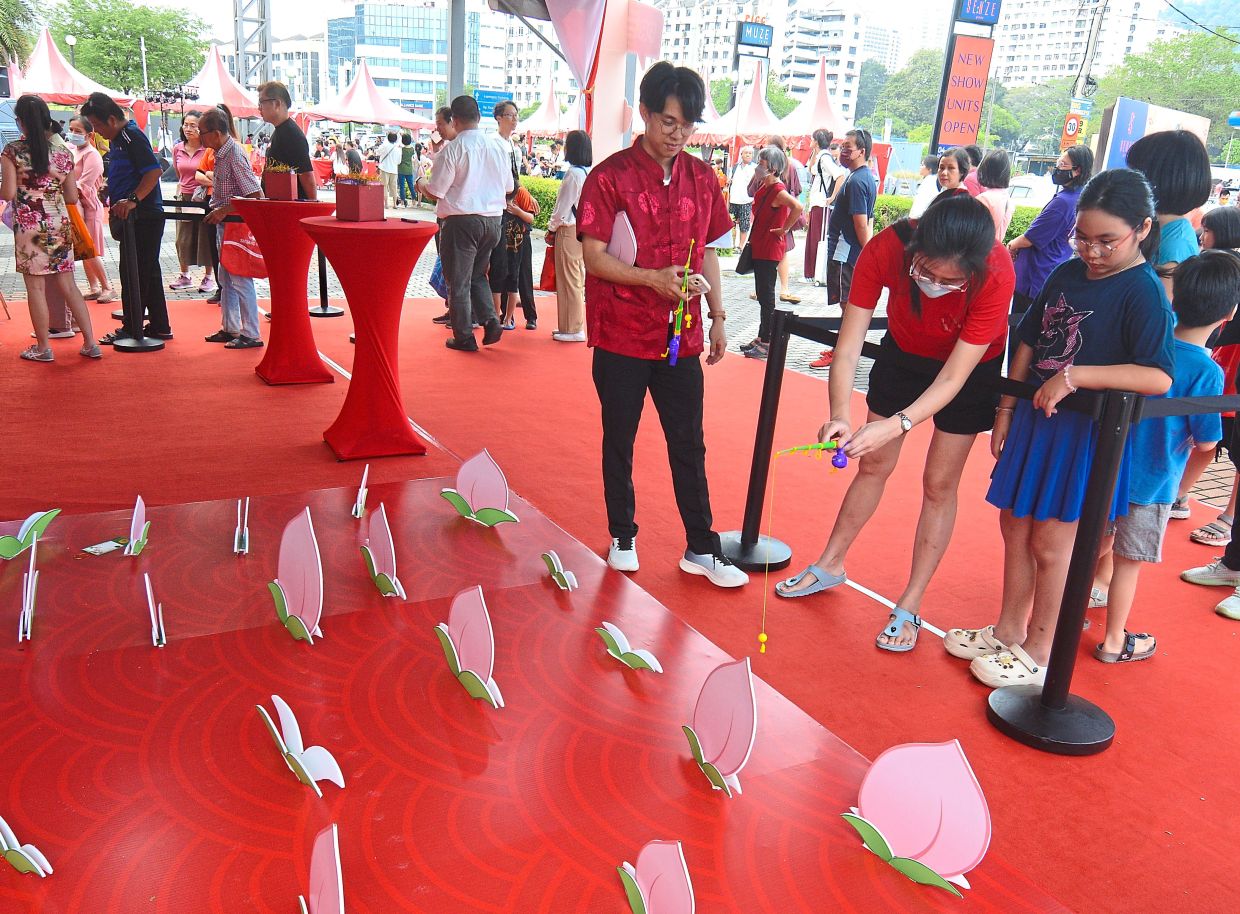 Visitors ‘fishing’ for peaches during the open house at PICC. 