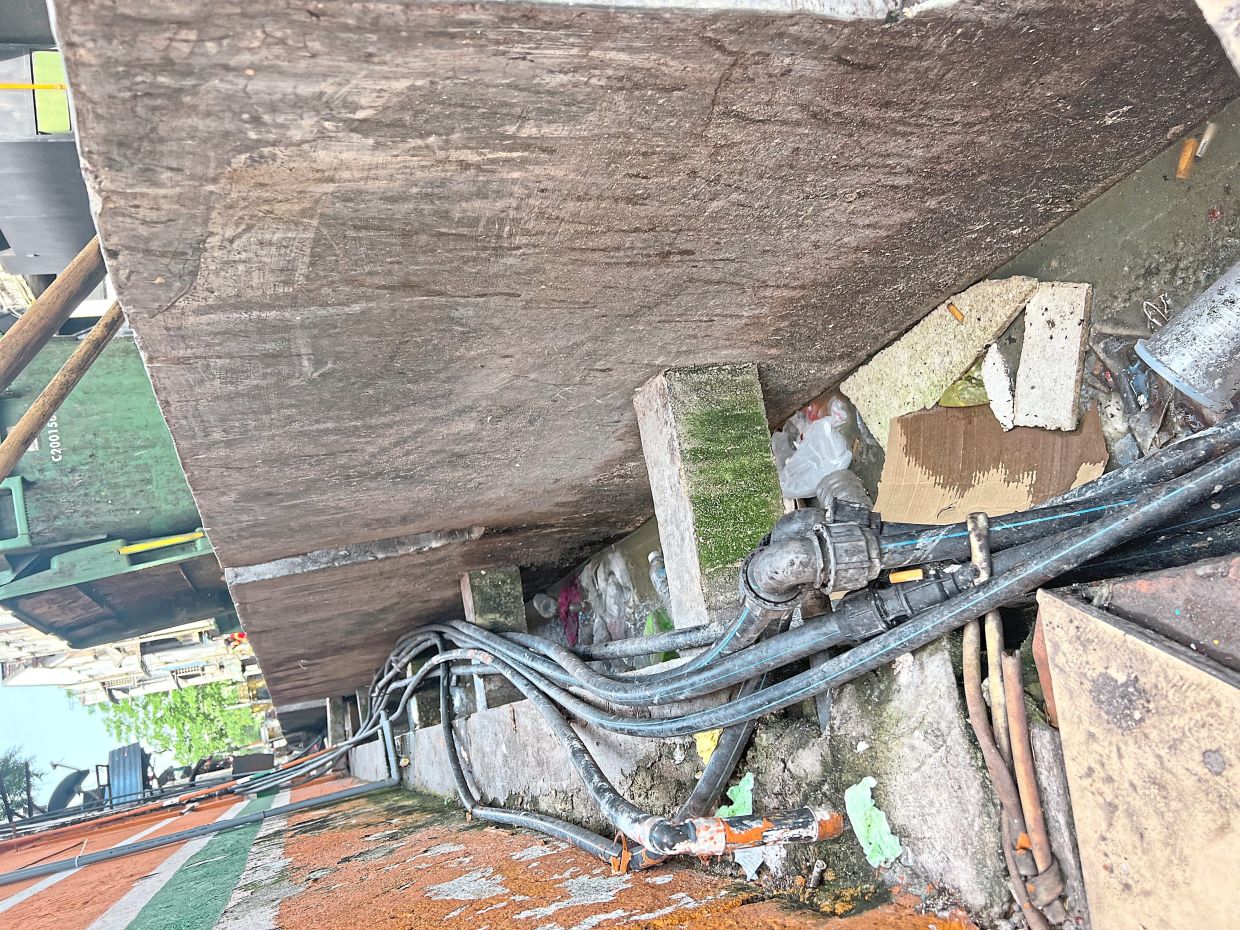 Illegally installed water pipes snaking in drains in Jalan Khoo Teik Ee, Kuala Lumpur, hamper cleaning efforts.