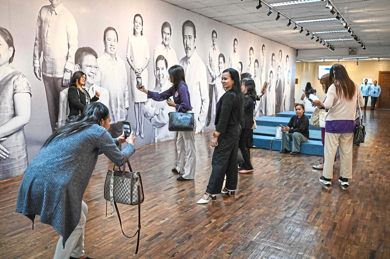 Dedicated bunch: Members of the group ‘Divorce for the Philippines, Now!’ preparing to attend a closed-door meeting at the Senate of the Philippines. — AFP