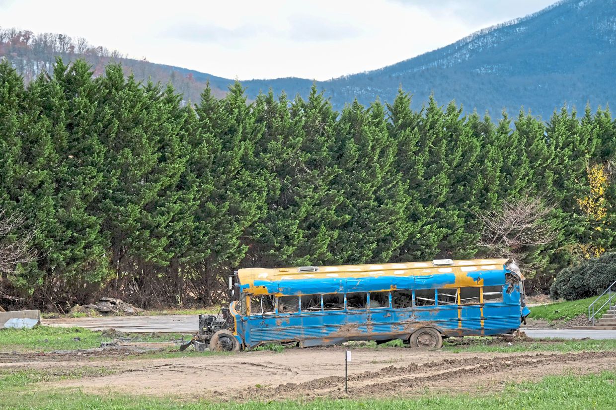 A bus normally used for transporting whitewater rafters lies wrecked as a result of Hurricane Helene. — AP