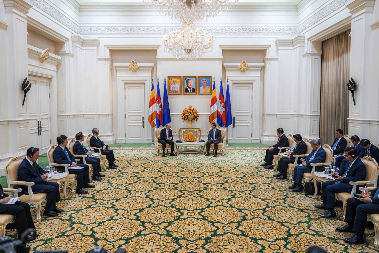 In this photo released by Agence Kampuchea Press (AKP), Cambodian Prime Minister Hun Manet (center right) sits together with Communist Party Secretary Yin Li (center left) during a welcome meeting at the Peace Palace in Phnom Penh, Cambodia, Monday, February. 24, 2025. -- AKP via AP