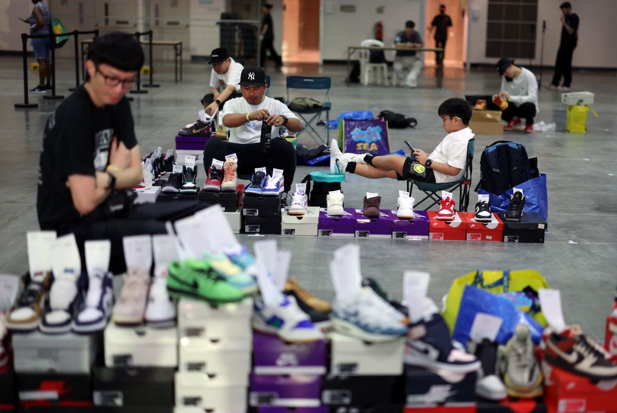 Thor, 40, and son T.J, 9 wait to trade sneakers at Sneaker Con Southeast Asia in Singapore. - Photo from Reuters/Edgar Su