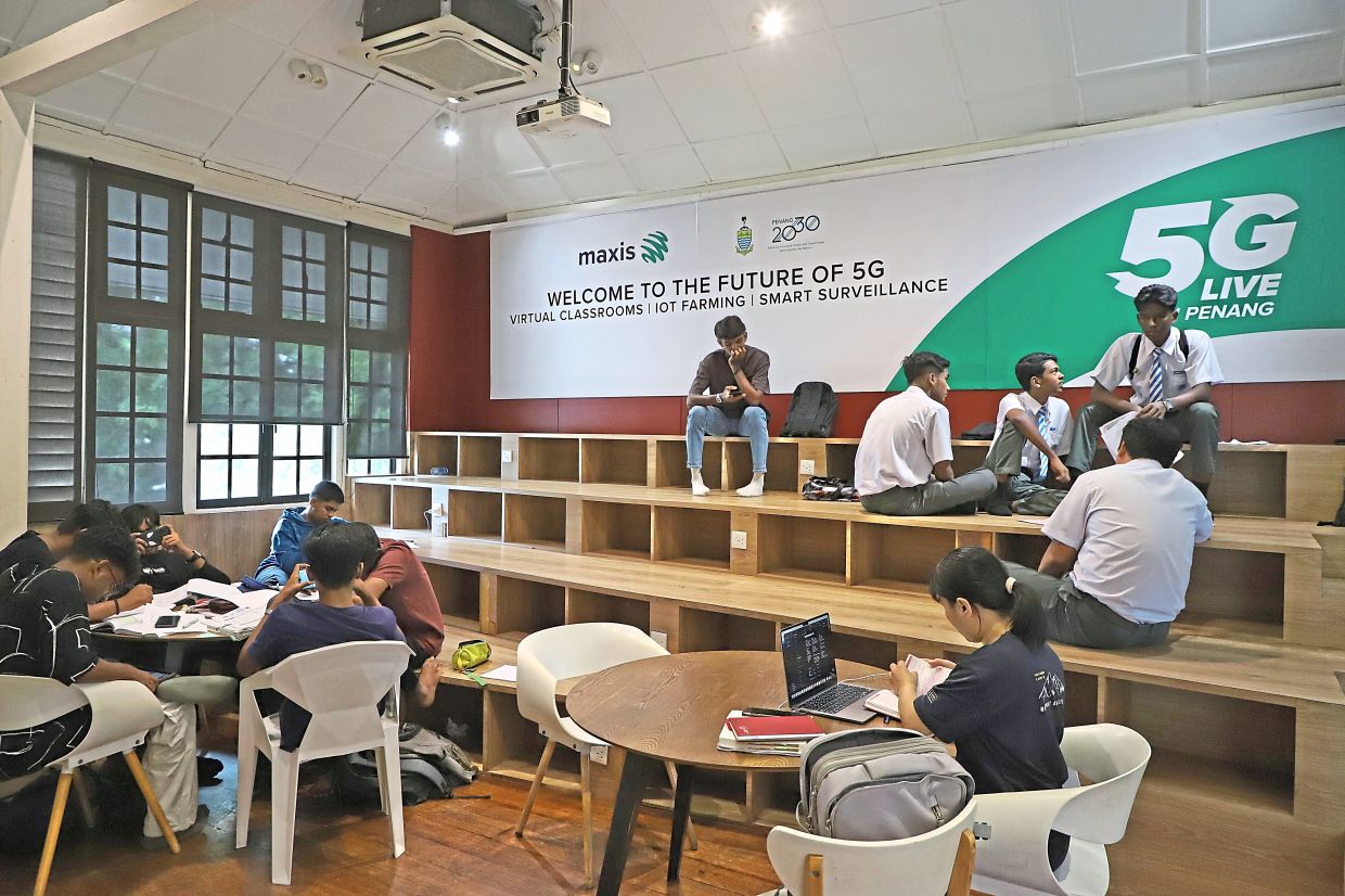 Students doing their revision at the amphitheater area at Penang Digital Library in Jalan Masjid Negeri. — LIM BENG TATT/The Star