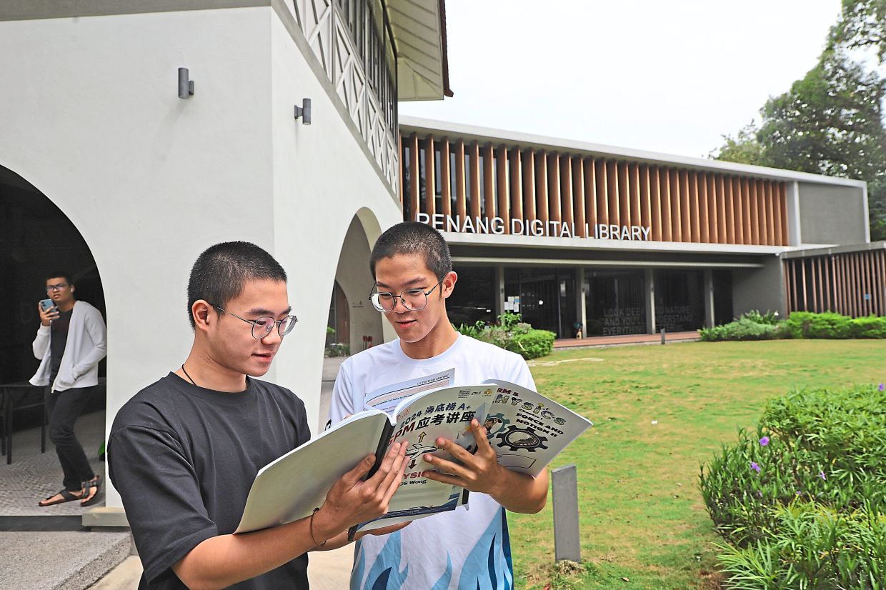 Adrian Loo Shan Chia (left) and Chuah Ren Kit, both 17, meet up at the Penang Digital Library in Jalan Masjid Negeri for their revisions.