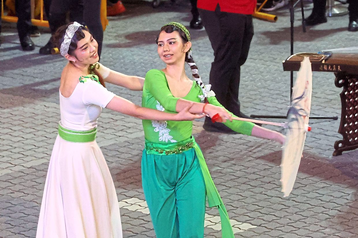 Two dancers, portraying Chinese folklore characters of the White Snake and Green Snake, performing during the Chingay parade to celebrate the Year of the Snake.