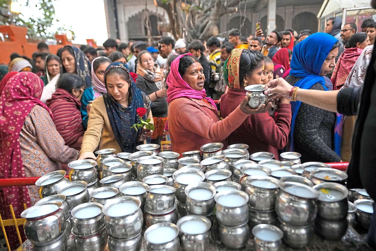 Hindu devotees queueing to offer prayers at a temple during the Shivaratri festival in Jammu. — AFP/AP