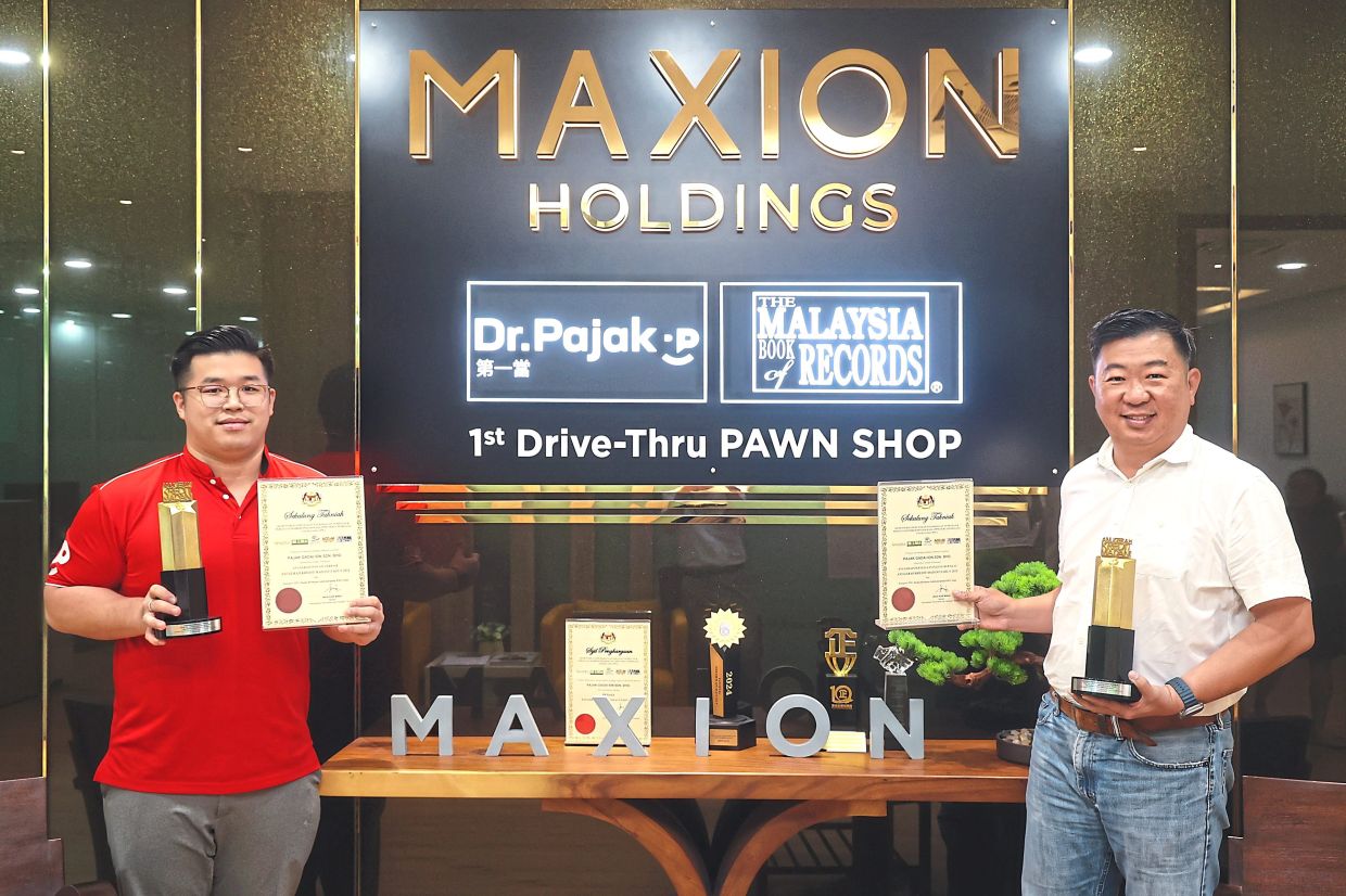 Maxion Holdings Sdn Bhd managing director Tan Wang Chang (right) and marketing and branding head Marcus Chew with the two awards that Dr. Pajak won in the inaugural 2024 Madani Credit Awards for the Most Valuable Pawn Shop and Most Innovative Pawn Shop.