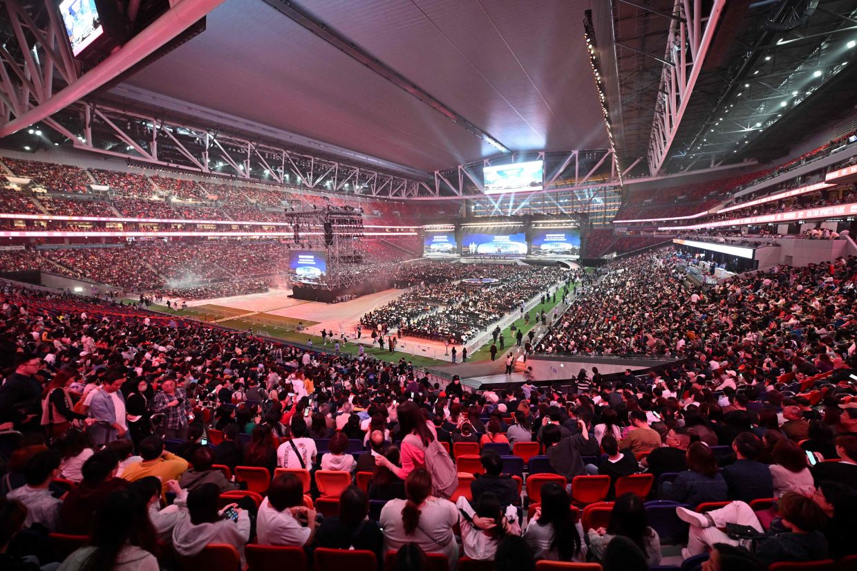 The crowd watches the opening ceremony of the Kai Tak Sports stadium, a multi-purpose sports venue at the site of the former Kai Tak Airport in Kowloon, Hong Kong on March 1, 2025. Hong Kong's years-long plan for a sprawling sports complex came to fruition as officials and celebrities opened the 3.86 billion USD Kai Tak Sports Park at its centrepiece 50,000-seat stadium. -- Photo by Peter PARKS / AFP