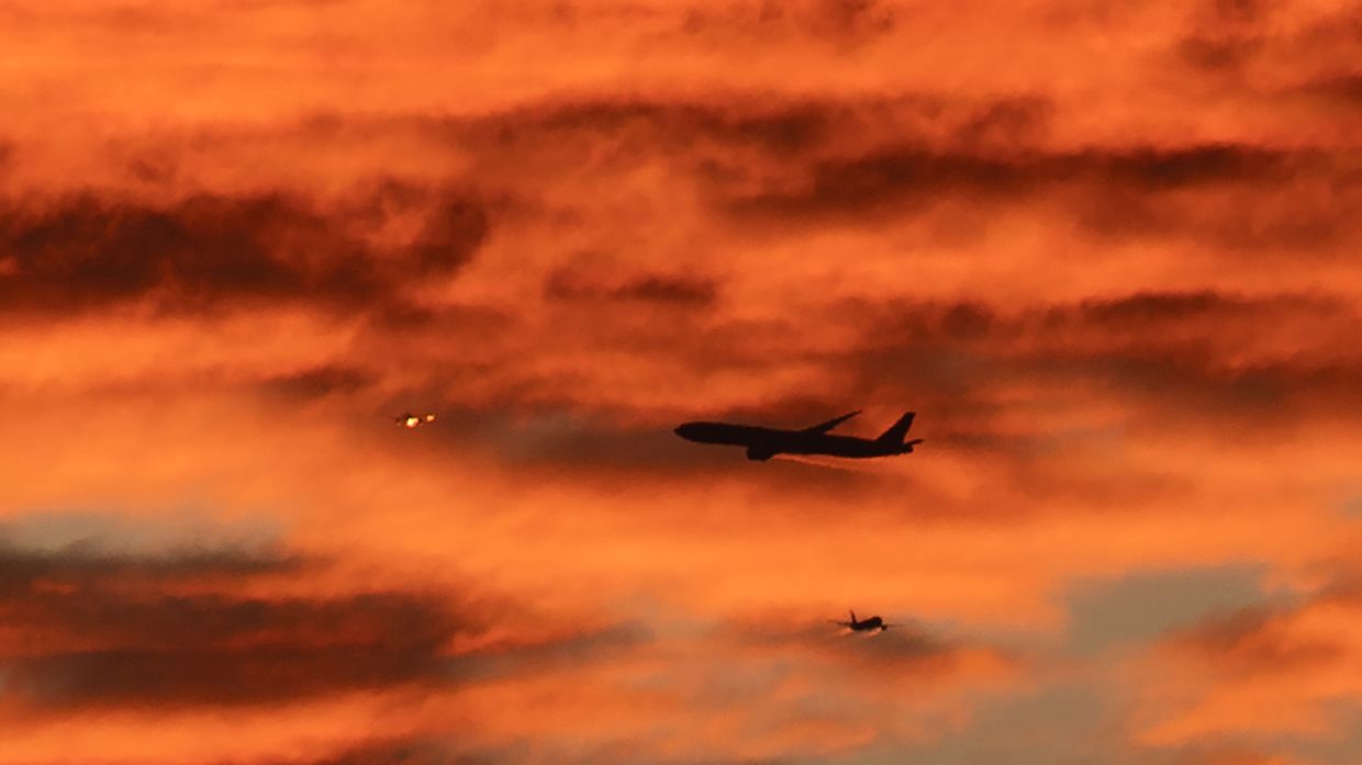 Three planes fly over Bataan province as the sun sets in Manila on Saturday, March 1, 2025.-- Photo by Ted ALJIBE / AFP