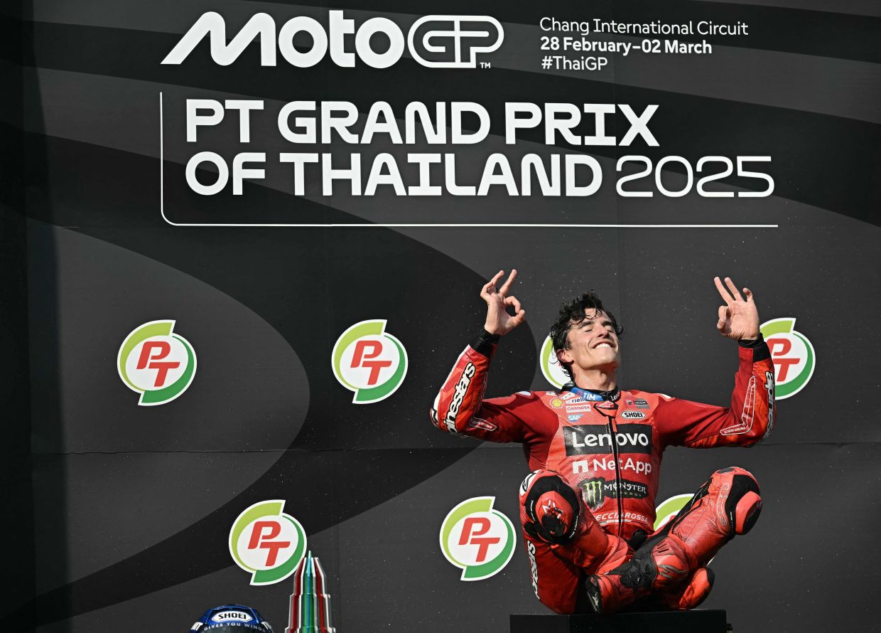 Ducati Lenovo's Spanish rider Marc Marquez celebrates on the podium after winning the MotoGP Thailand Grand Prix at the Buriram International Circuit in Buriram on Sunday, March 2, 2025. -- Photo by Lillian SUWANRUMPHA / AFP