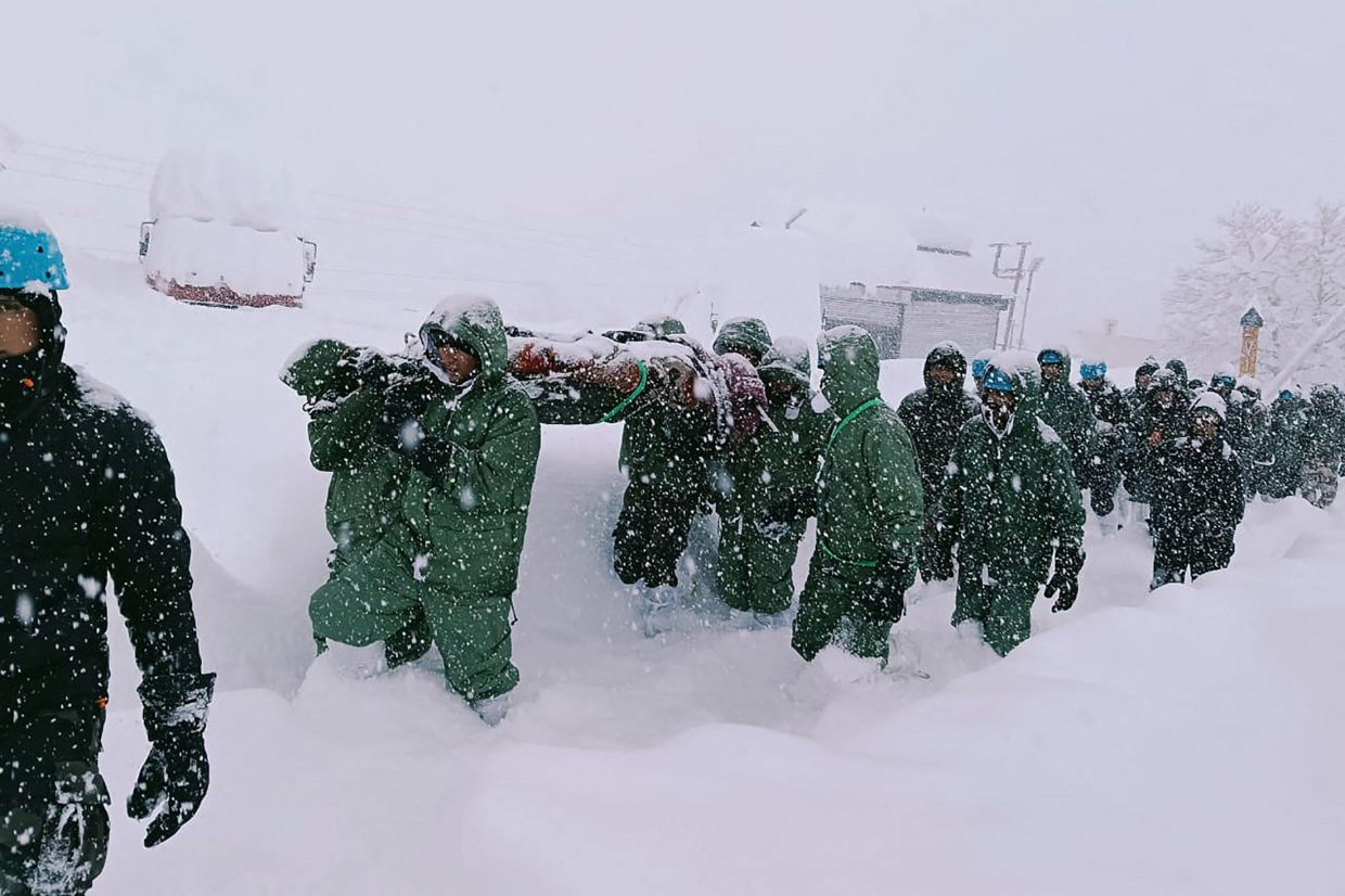 Rescuers carry Border Roads Organisation (BRO) workers after an avalanche near Mana village in Chamoli district. Over 40 construction workers were missing while 15 others were rescued after an avalanche in India's Himalayan state of Uttarakhand following heavy snowfall, officials said. - AFP
