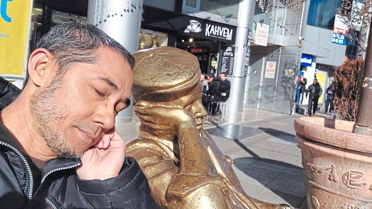 The writer at Eskisehir, where the city is littered with unique golden sculptures like this one. — Photos: SA MP