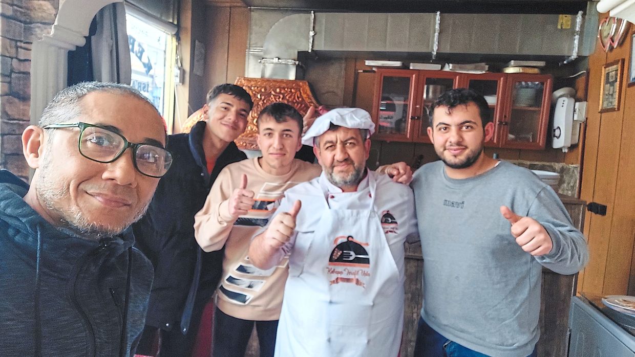In Erzurum, the writer (far left) met a friendly kebab restaurant owner (second from left) and his three sons, who refused payment for his meal.