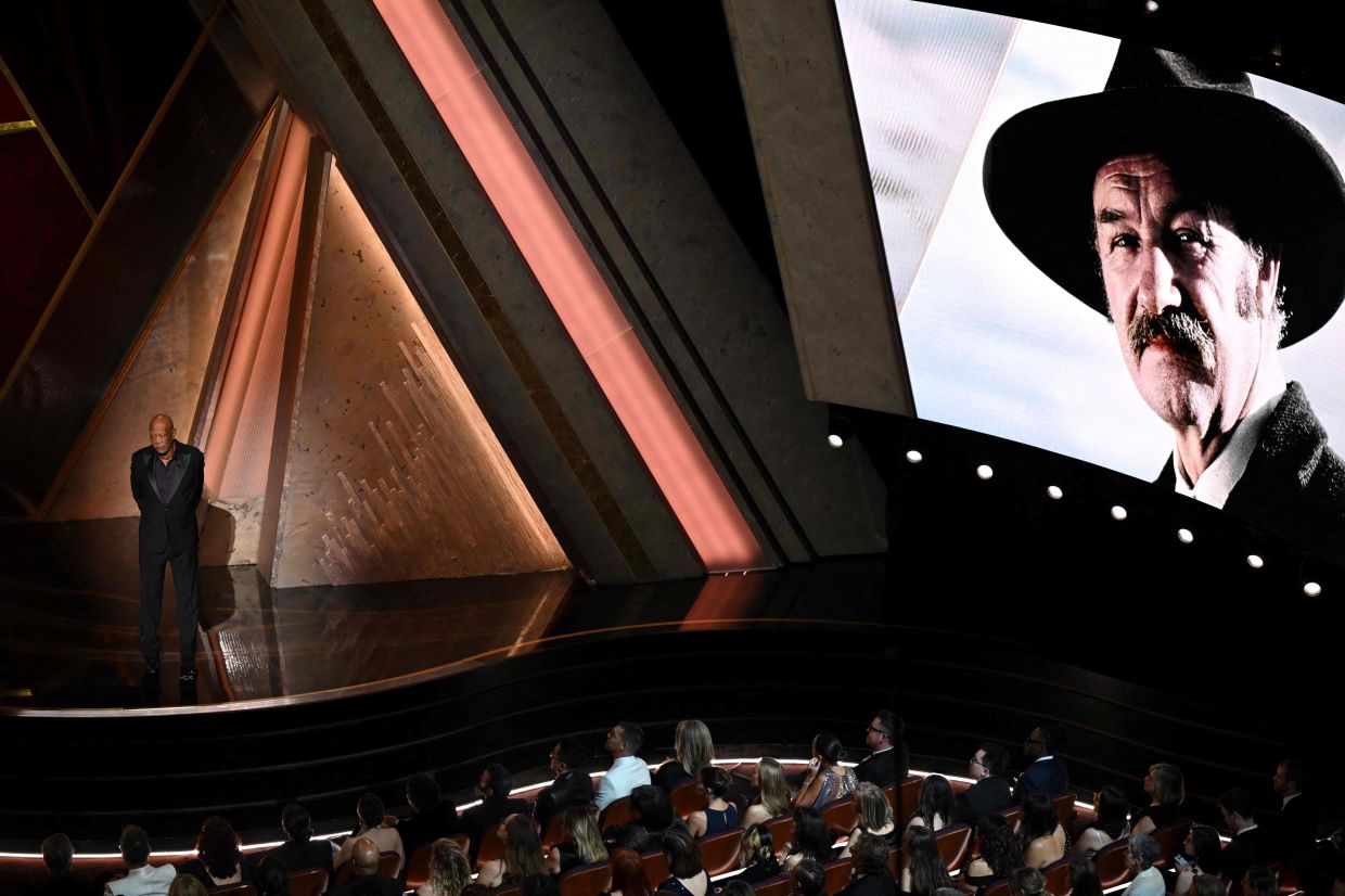 An image of late US actor Gene Hackman is seen on a screen as US actor Morgan Freeman stands onstage during the 97th Annual Academy Awards at the Dolby Theatre in Hollywood, California on March 2, 2025. Photo: AFP