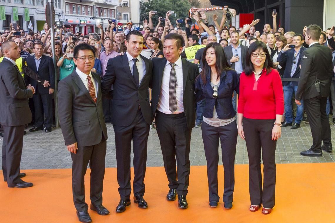 Peter Lim (centre) attending his first Valencia game after taking over the La Liga club in 2014. - VALENCIA CF
