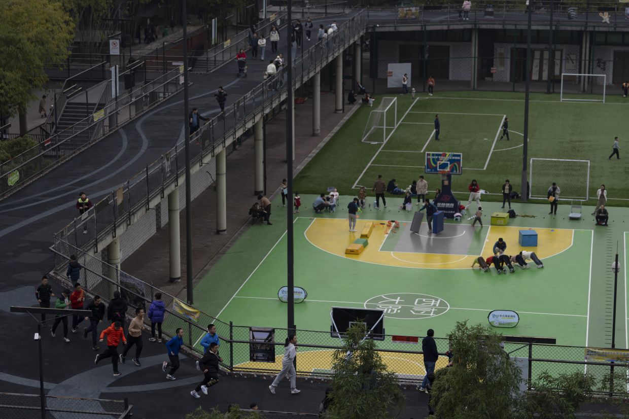 Visitors enjoy the sports facilities at the West Village project by Pritzker Architecture Prize winner Liu in Chengdu. Photo: Ng Han Guan/AP