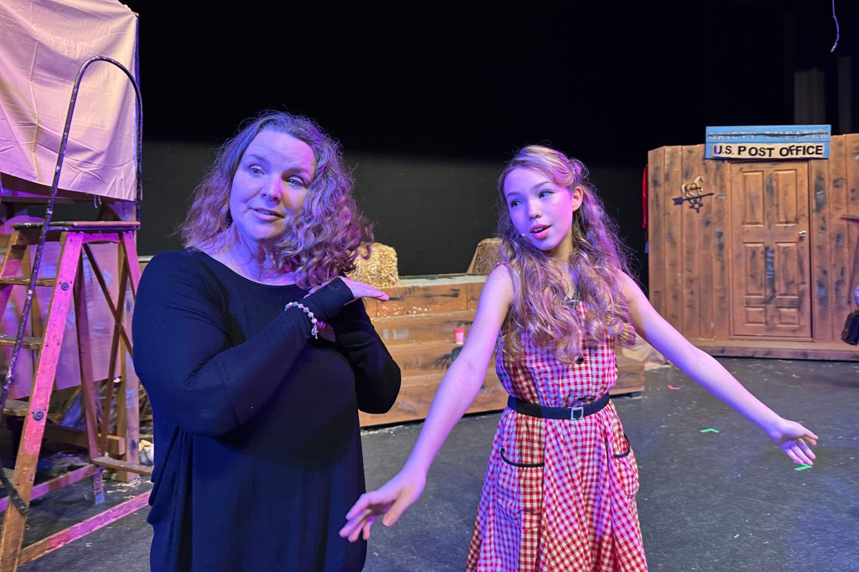 Lara Ganz, left, director of Theatre Palisades Youth, works on blocking with Anna Telehowski, 14, right, on opening night of Crazy for You as the group returns to the stage despite losing their in the Palisades fire, Los Angeles, Calif., Feb. 28, 2025. (AP Photo/Jocelyn Gecker)