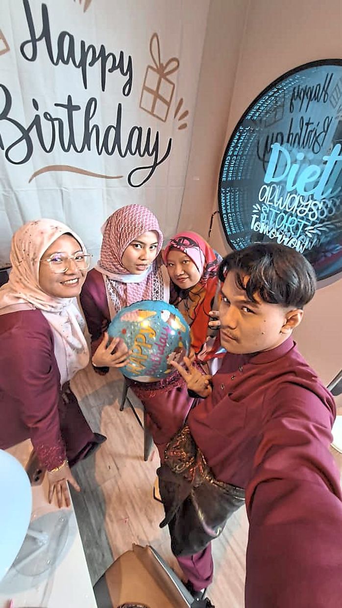 Sahdatun (third from left) with her now adult children. 