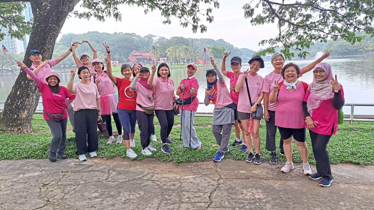 Kim Foong (eighth from right) with other cancer survivors during a walk at Shah Alam lake. 
