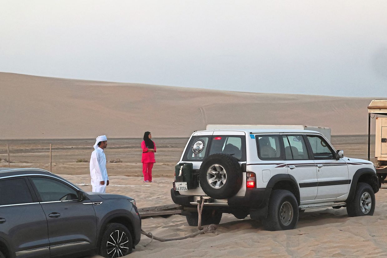 Rescuers towing out a vehicle stuck in the sand in November. 