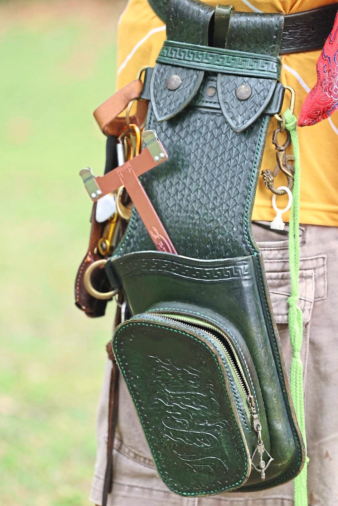 A handmade leather quiver in all its glory, replete with various patterns and a regal dragon motif.