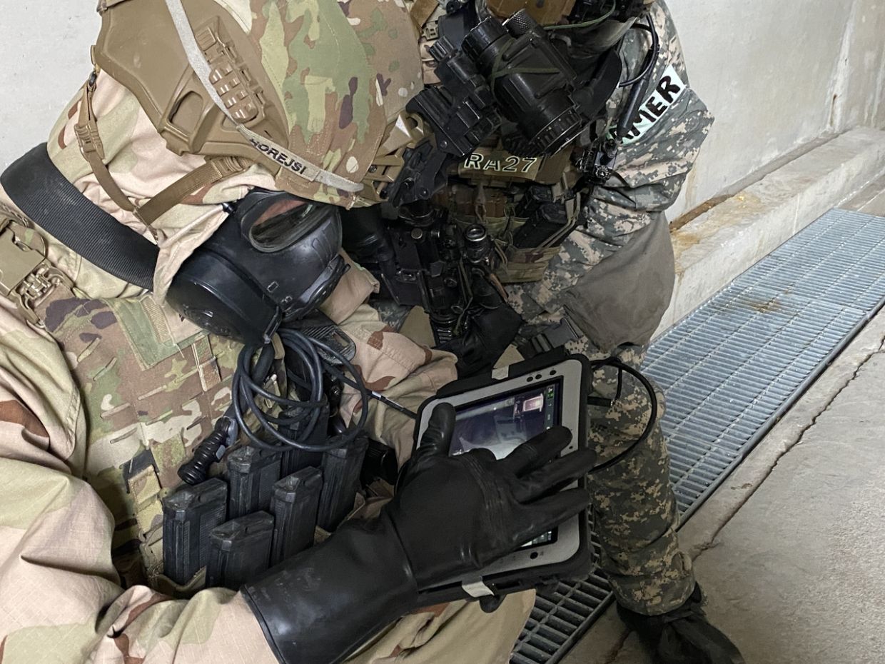Members of the Counter-WMD Task Force operate the PackBot through a control panel, monitoring a building's interior via the live feed on its screen. - Photo: The Korea Herald