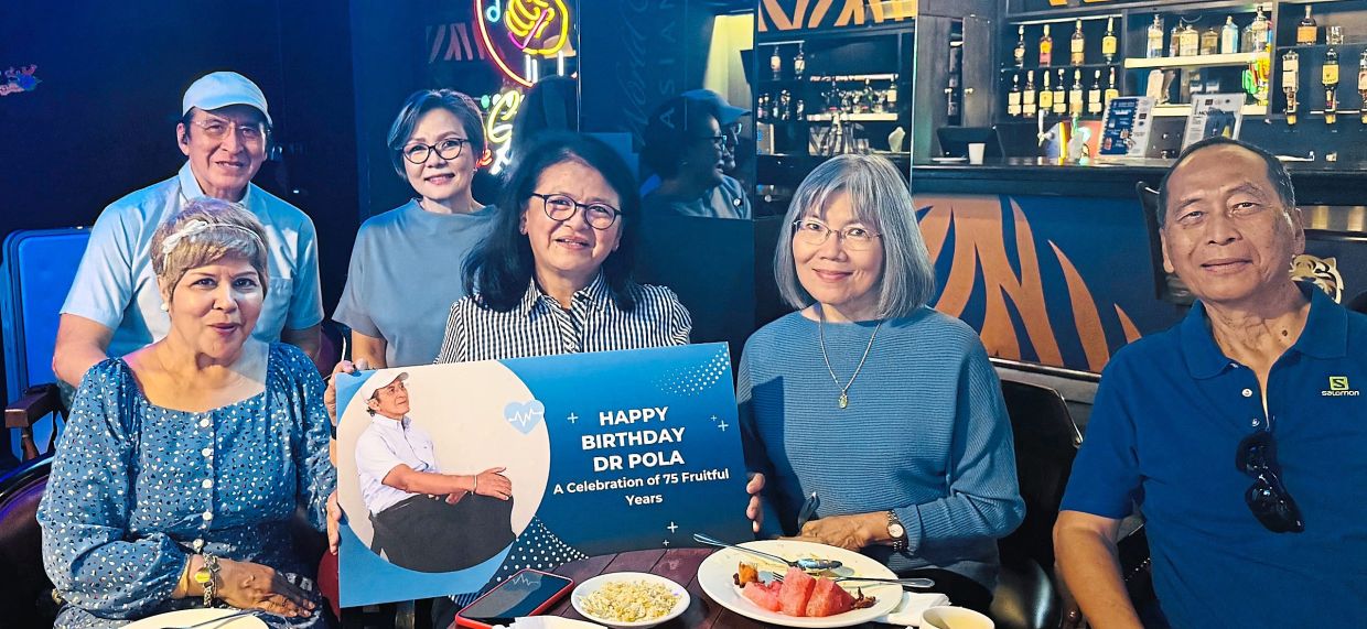 The writer (back row, left) celebrating his birthday with SeniorsAloud members. Its founder Lily Fu is second from the right.