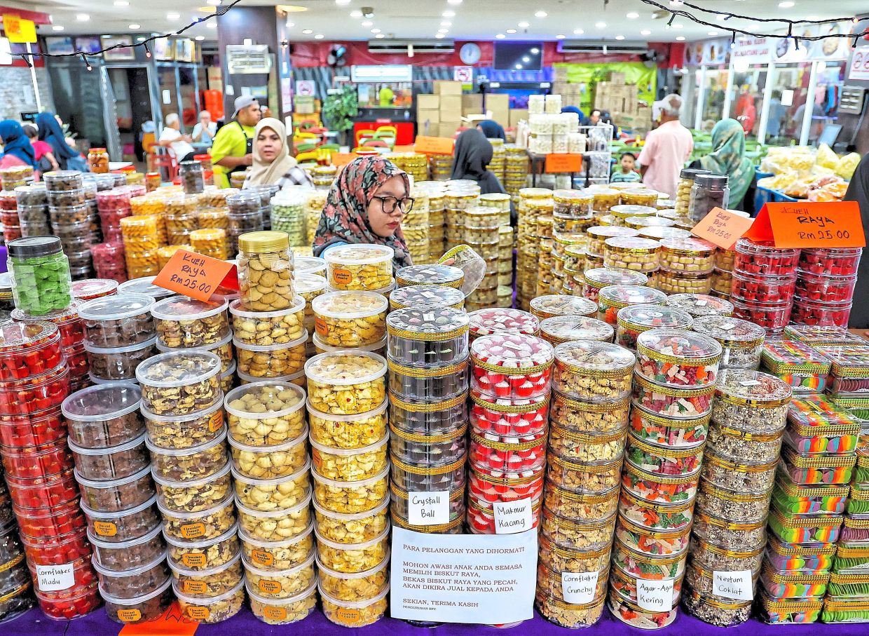 Stalls at the PKNS Complex in Shah Alam, are stacked with jars of snacks, drawing customers eager to stock up for Hari Raya.