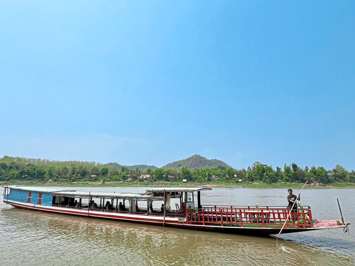 A ‘slow boat’ carrying tourists across the Mekong river.