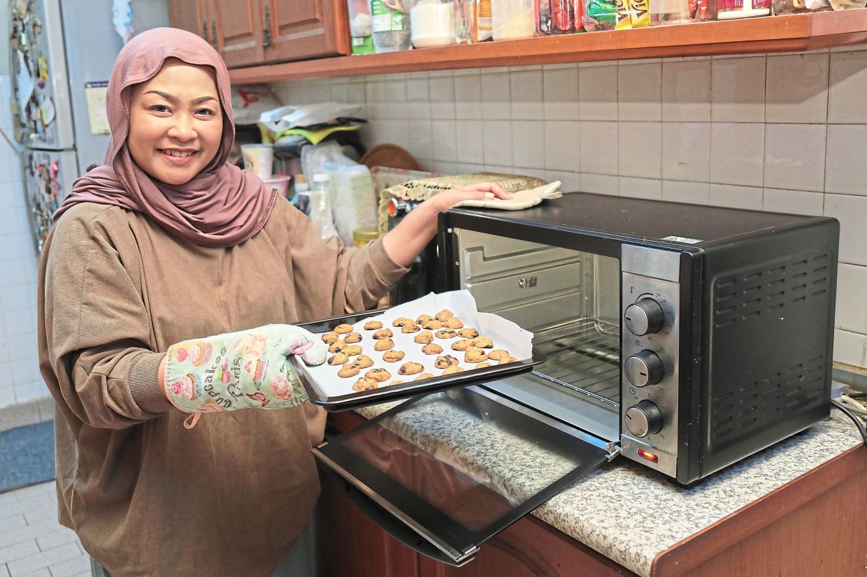 Zuraini prepares homemade Raya cookies for the season.