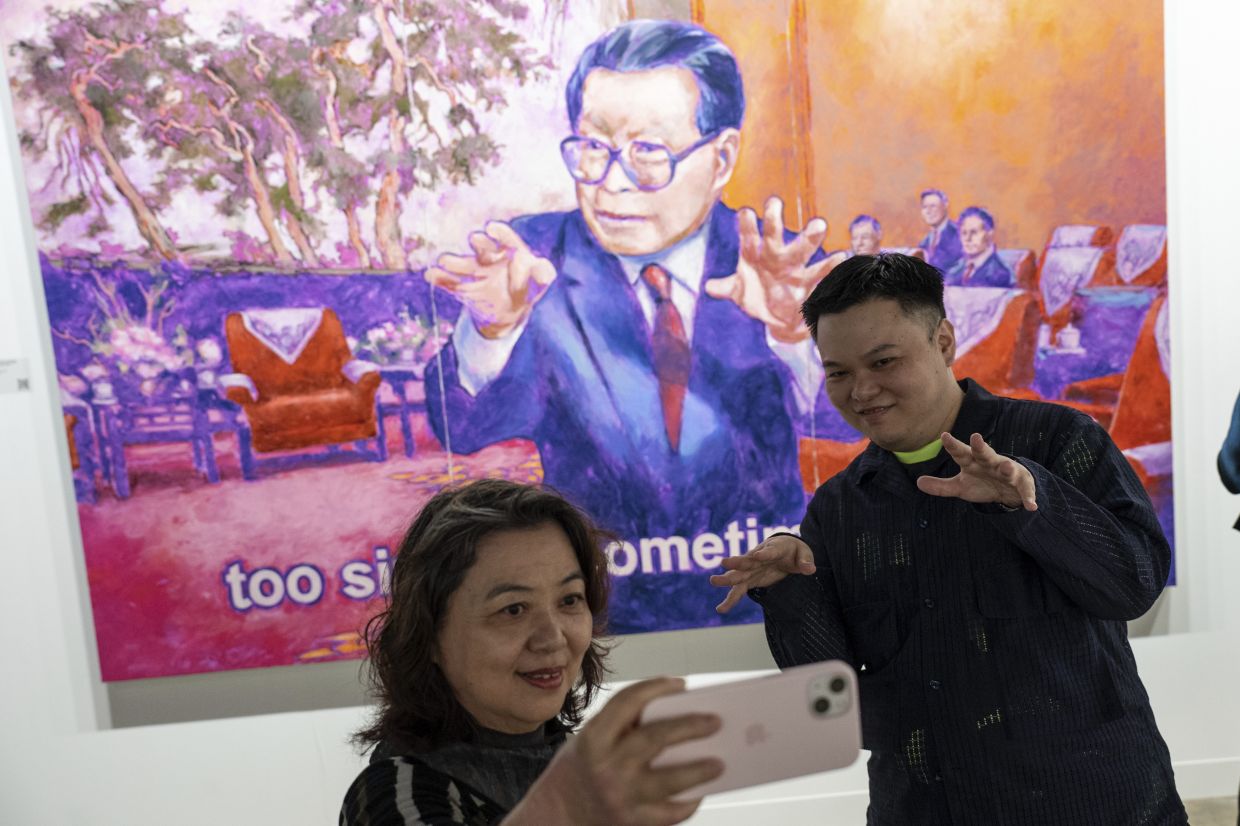 Visitors snap a selfie with Chow's artwork 'Great Hall Of The People On October 27, 2000' at Art Basel Hong Kong. Photo: AP