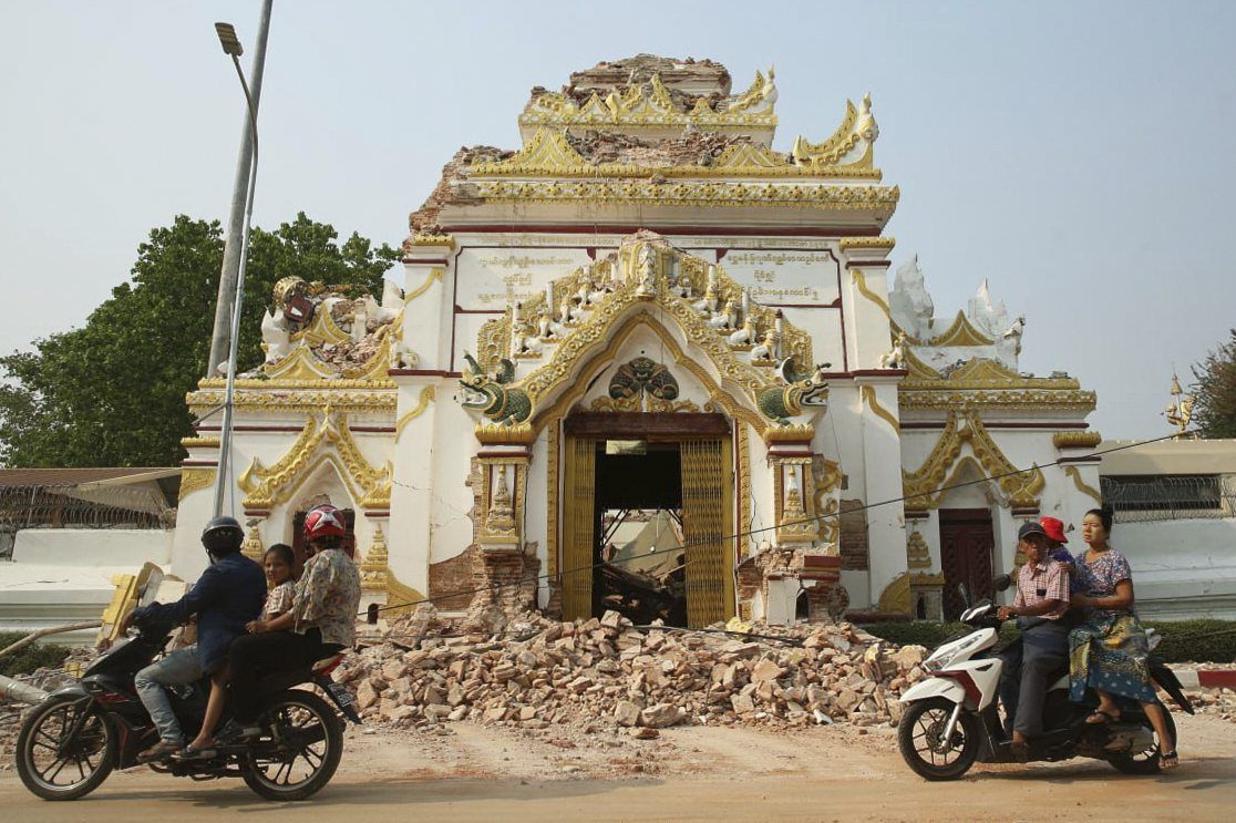 Locals past by a partially damaged building in the aftermath of an earthquake in Mandalay, Myanmar on Saturday, March 29, 2025. -- Myo Kyaw Soe/Xinhua via AP