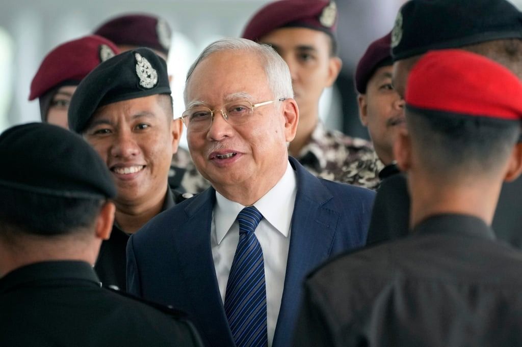 Former Malaysian prime minister Najib Razak arrives at a court in Kuala Lumpur last year escorted by prison officers. Photo: AP
