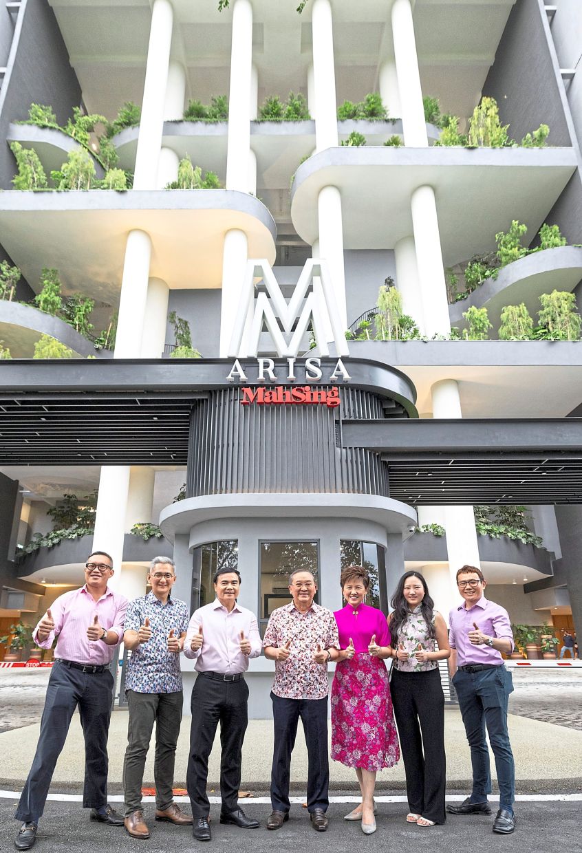 Leong (centre), Voon (third from left) and Mah Sing’s top management posing for a group photo at the entrance to M Arisa during an event to celebrate its completion and several notable achievements.