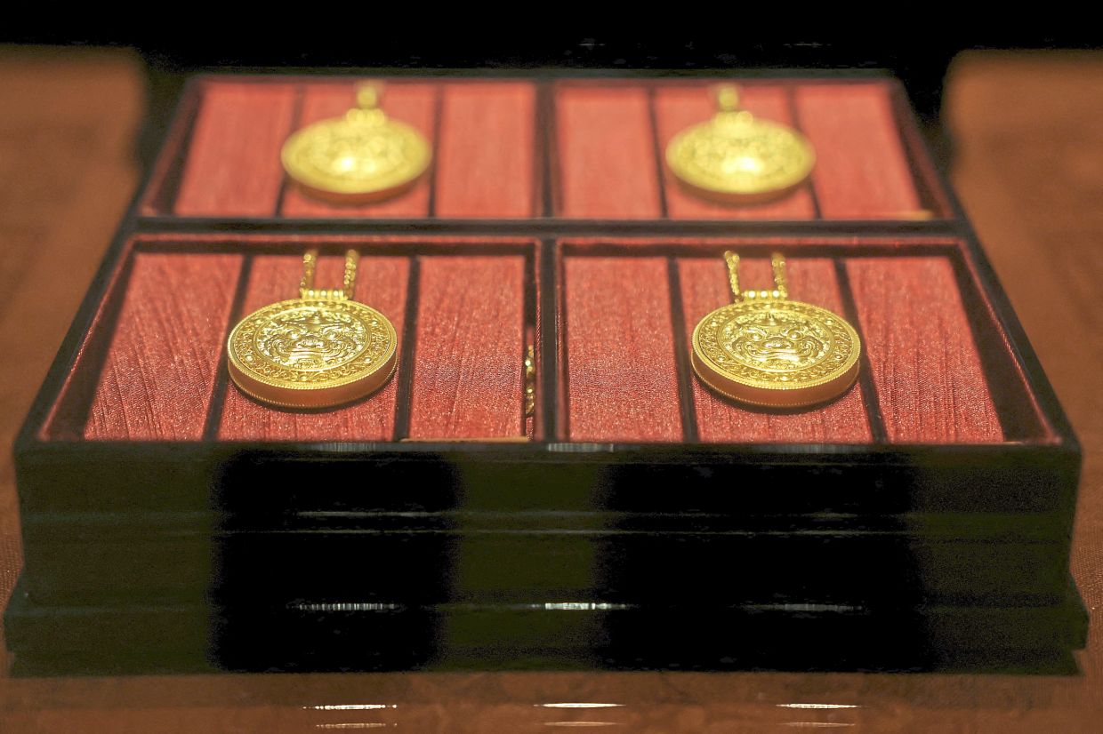 Gold necklaces in a display case at a Laopu Gold jewellery store in Beijing. — Reuters