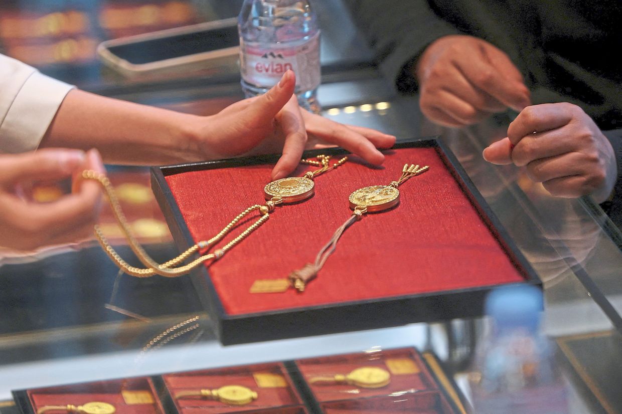 A staff member showing products to a customer. — Reuters