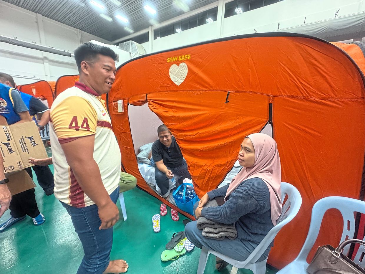 Fiqrie (left) talking to Azizah (right) at the relief centre in Masjid Putra Heights.