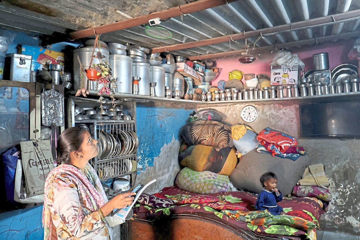 A data collector recording the reading on a data logger. — Reuters 