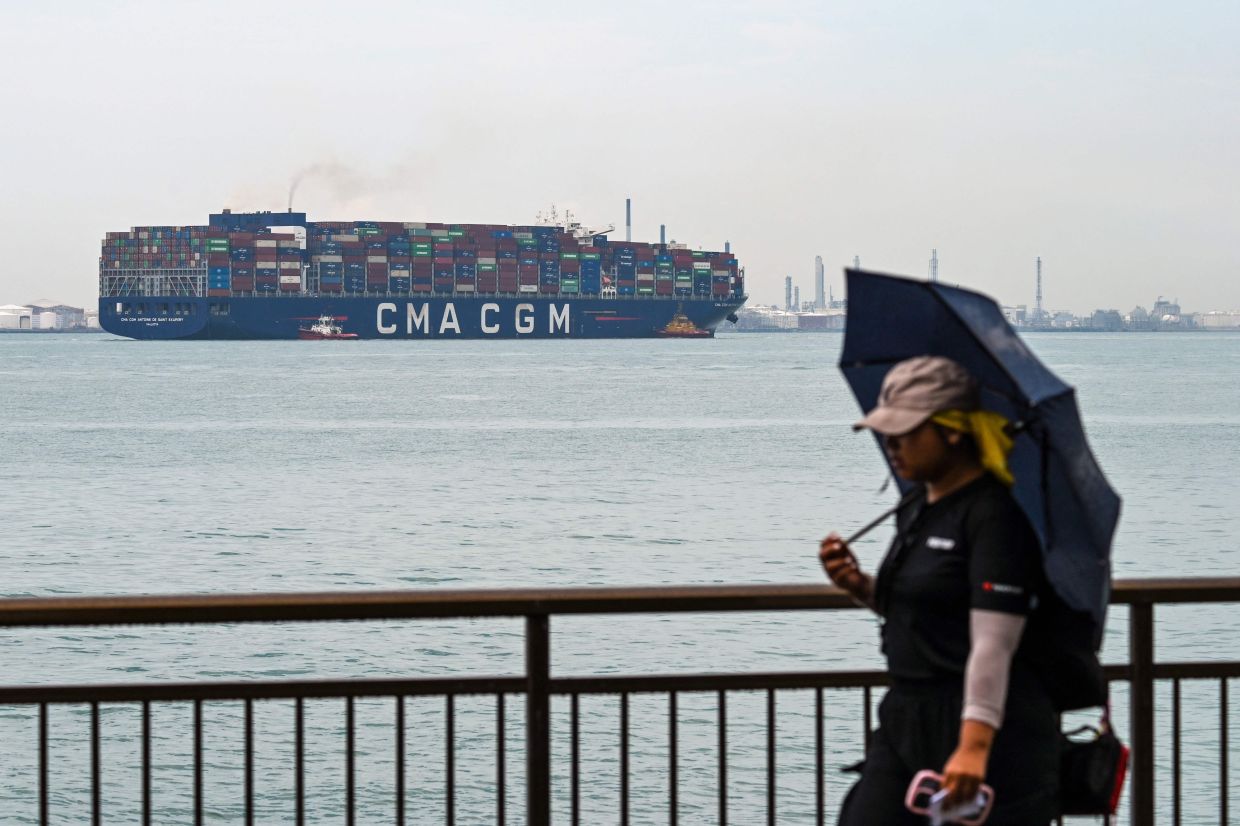 A fully loaded container vessel leaves the Pasir Panjang terminal port in Singapore on Friday, April 4, 2025. US President Donald Trump ignited a potentially ruinous global trade war on April 2 as he slapped 10 percent tariffs on imports from around the world and harsh extra levies on key trading partners. -- Photo by Roslan RAHMAN / AFP