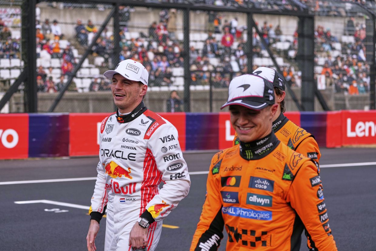Red Bull driver Max Verstappen of the Netherlands is accompanied with McLaren driver Lando Norris of Britain and McLaren driver Oscar Piastri of Australia after qualifying session for the Japanese Formula One Grand Prix at the Suzuka Circuit in Suzuka, central Japan, Saturday, April 5, 2025. -- AP Photo/Shuji Kajiyama